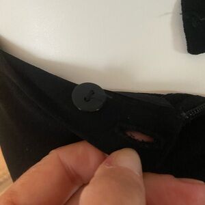 Black lined pleated skirt.  Two button waist, zipper back